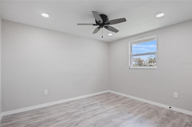 spare room featuring ceiling fan and light wood-type flooring