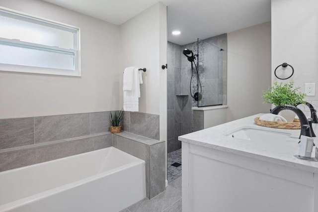 bathroom with vanity and independent shower and bath