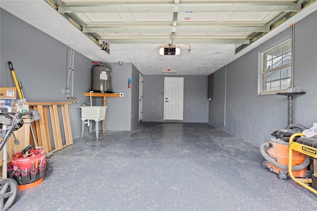 garage featuring a garage door opener, sink, and electric water heater