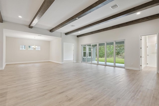 unfurnished room with a wealth of natural light, light hardwood / wood-style flooring, and a notable chandelier