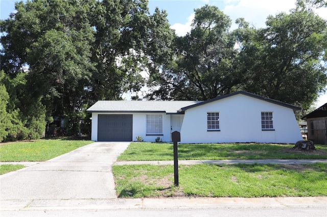 view of front facade with a front yard and a garage