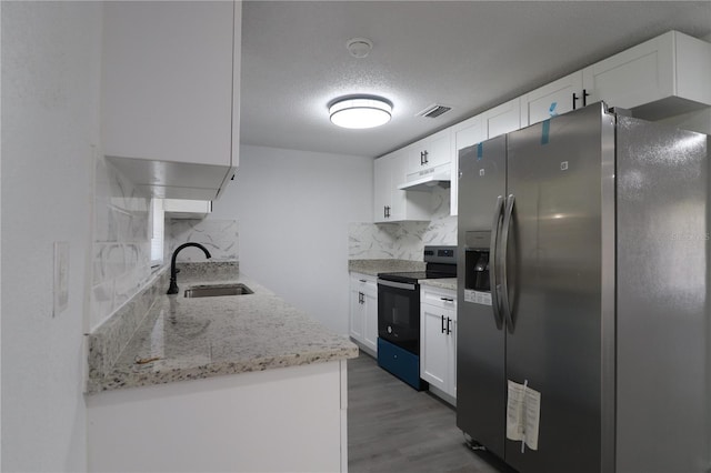 kitchen with hardwood / wood-style floors, sink, white cabinetry, and stainless steel appliances