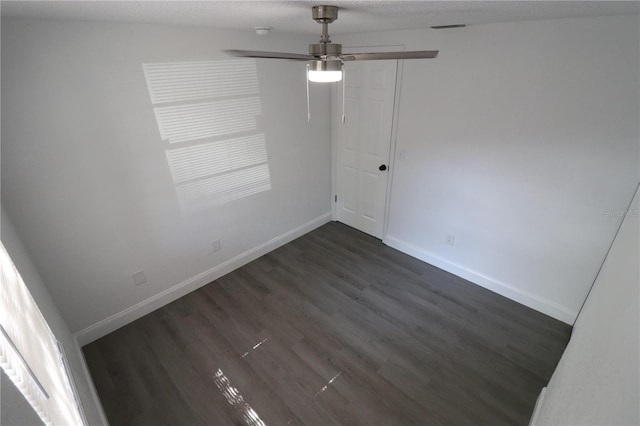 unfurnished room with dark wood-type flooring