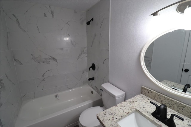 full bathroom with vanity, toilet, and tiled shower / bath