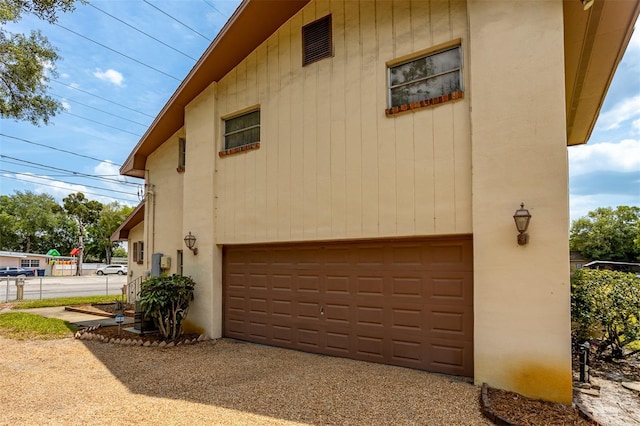 view of side of home with an attached garage