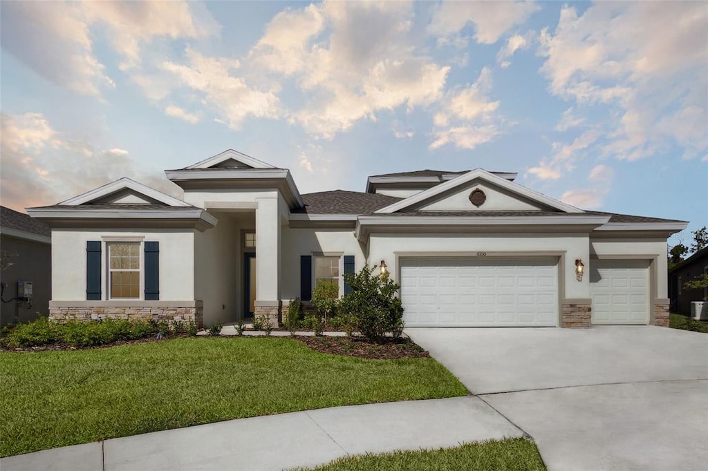 view of front of property featuring a garage and a front yard