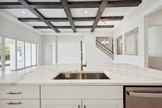 kitchen featuring sink, light stone countertops, stainless steel dishwasher, hanging light fixtures, and coffered ceiling