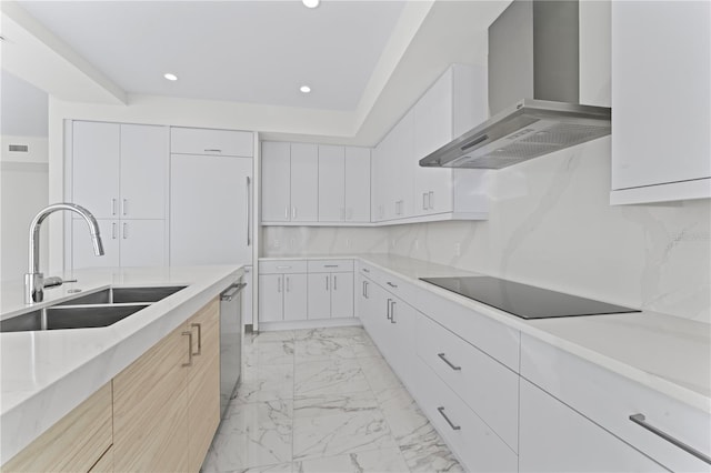 kitchen featuring black electric stovetop, stainless steel dishwasher, sink, wall chimney range hood, and white cabinets