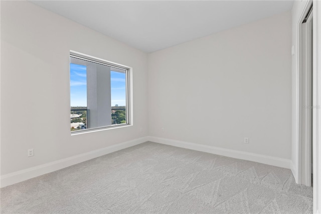 spare room featuring light colored carpet