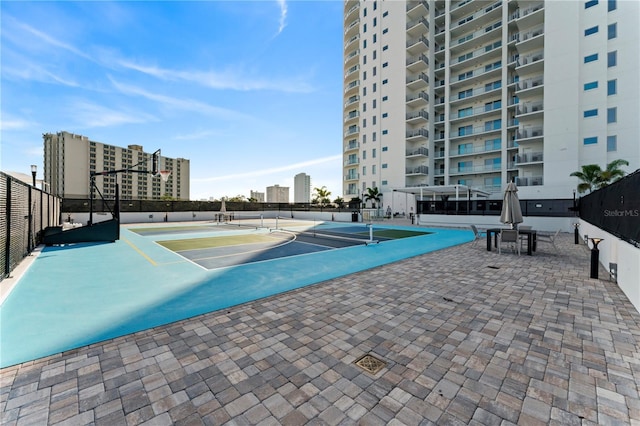 view of pool with tennis court