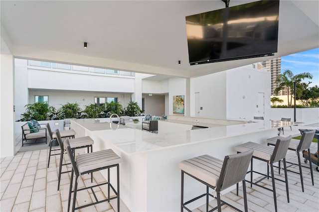 kitchen featuring kitchen peninsula, a kitchen breakfast bar, and white cabinetry