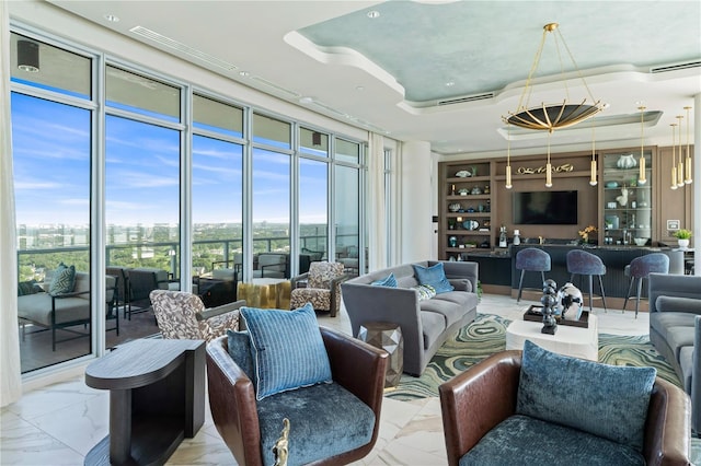 living room featuring a tray ceiling and a wealth of natural light