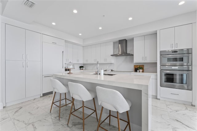 2910 W Barcelona St Unit 903, Tampa, FL 33629 - kitchen with wall chimney exhaust hood, marble finish floor, paneled refrigerator, and visible vents