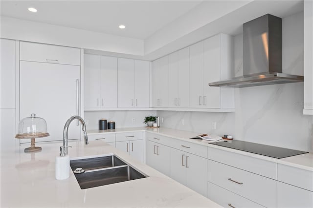 2910 W Barcelona St Unit 903, Tampa, FL 33629 - kitchen with wall chimney exhaust hood, black electric stovetop, a sink, and light countertops