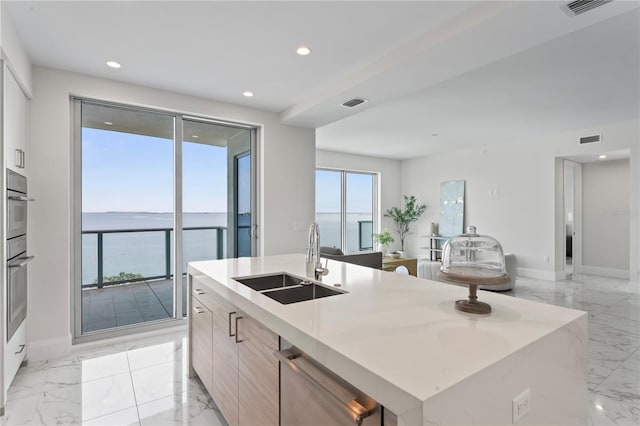 2910 W Barcelona St Unit 903, Tampa, FL 33629 - kitchen featuring modern cabinets, marble finish floor, a sink, and an island with sink