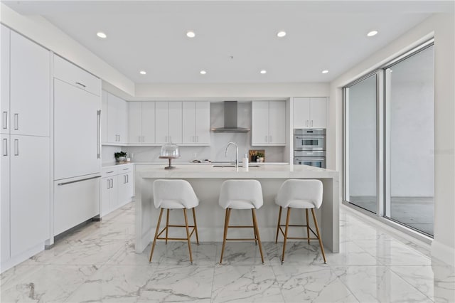 2910 W Barcelona St Unit 903, Tampa, FL 33629 - kitchen with wall chimney range hood, built in refrigerator, a breakfast bar area, double oven, and light countertops