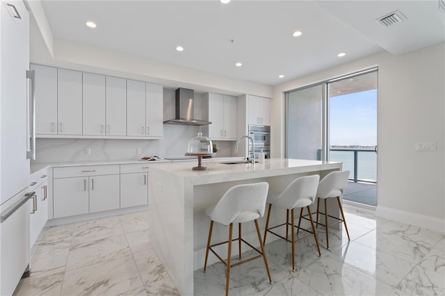 2910 W Barcelona St Unit 903, Tampa, FL 33629 - kitchen with wall chimney exhaust hood, visible vents, a sink, and marble finish floor