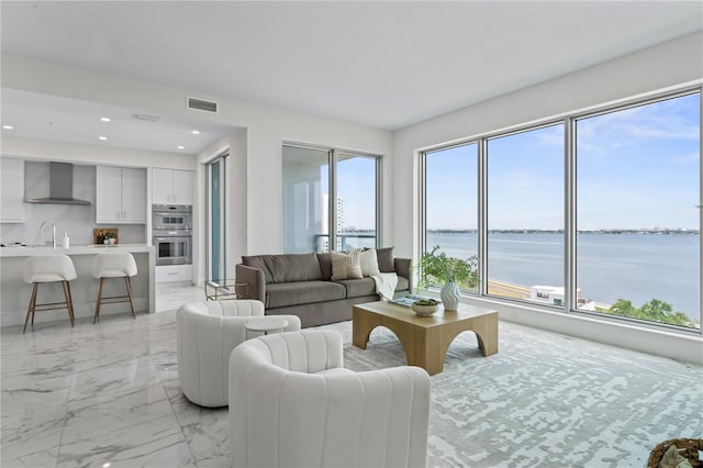 2910 W Barcelona St Unit 903, Tampa, FL 33629 - living area featuring marble finish floor, recessed lighting, visible vents, and a water view