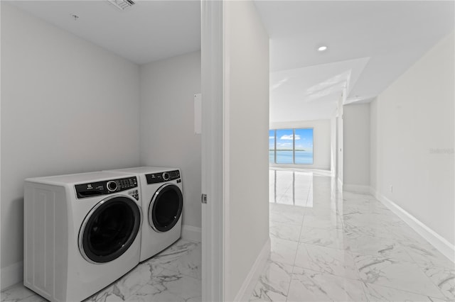 2910 W Barcelona St Unit 903, Tampa, FL 33629 - laundry room featuring baseboards, marble finish floor, washer and dryer, and laundry area