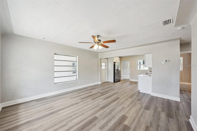 unfurnished living room with ceiling fan and light hardwood / wood-style floors