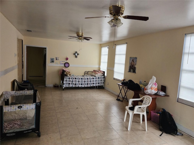 bedroom with ceiling fan and multiple windows