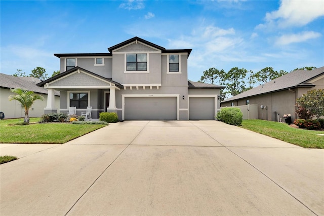 view of front of property featuring a garage, covered porch, and a front yard