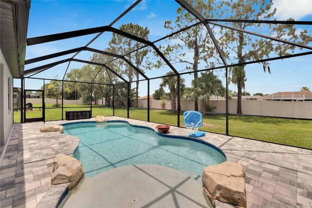 view of swimming pool with glass enclosure, a patio area, and a yard