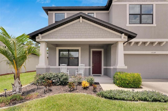 view of front of home with a porch and a garage