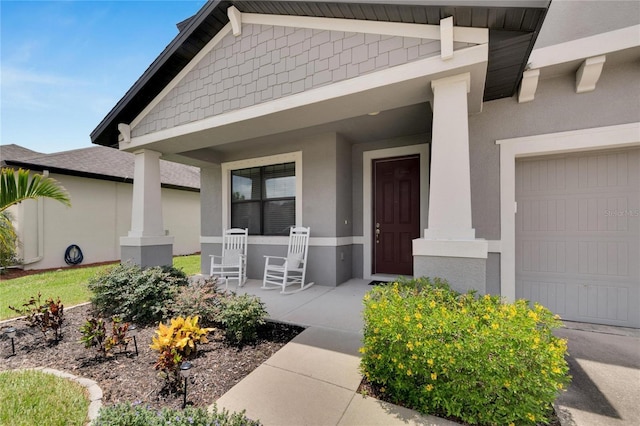 property entrance with a porch and a garage