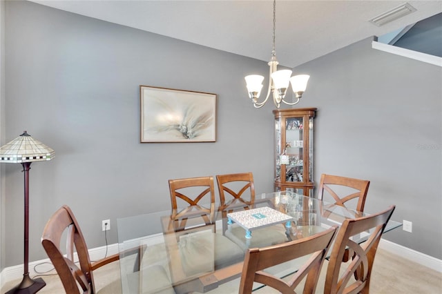 carpeted dining room with a chandelier