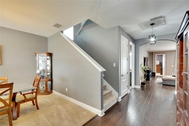 entrance foyer featuring wood-type flooring and a textured ceiling