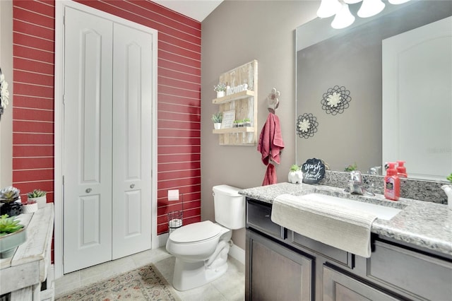 bathroom with tile patterned floors, vanity, and toilet