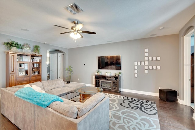 living room featuring ceiling fan and hardwood / wood-style flooring