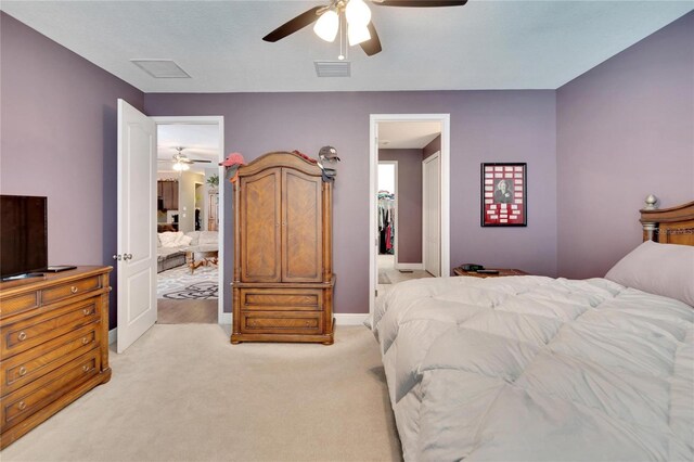 bedroom with ceiling fan and light carpet