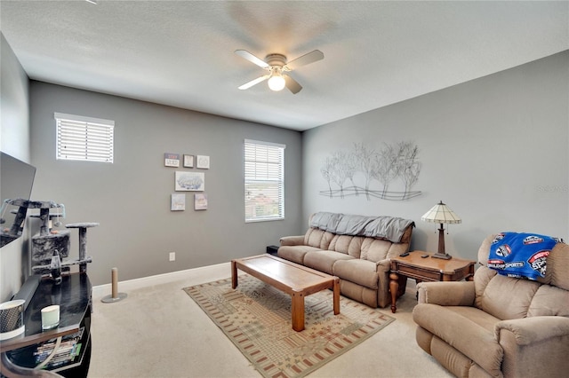 living room featuring ceiling fan and light colored carpet