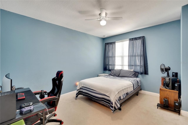 bedroom with ceiling fan and light carpet