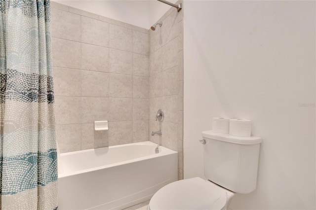 bathroom with toilet and shower / bath combo with shower curtain