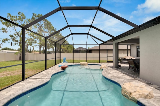 view of pool with a lawn, a lanai, and a patio