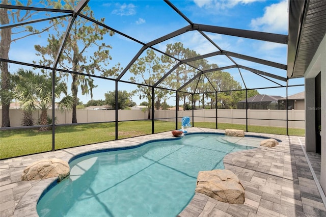 view of swimming pool with a lanai, a yard, and a patio