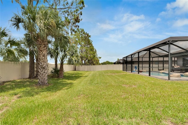 view of yard featuring a fenced in pool and a lanai