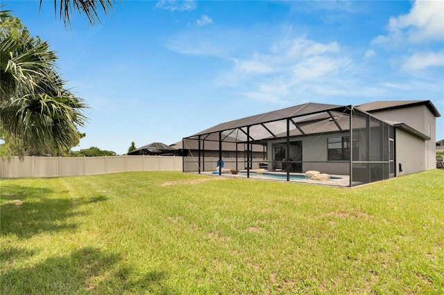 view of yard with a fenced in pool and glass enclosure