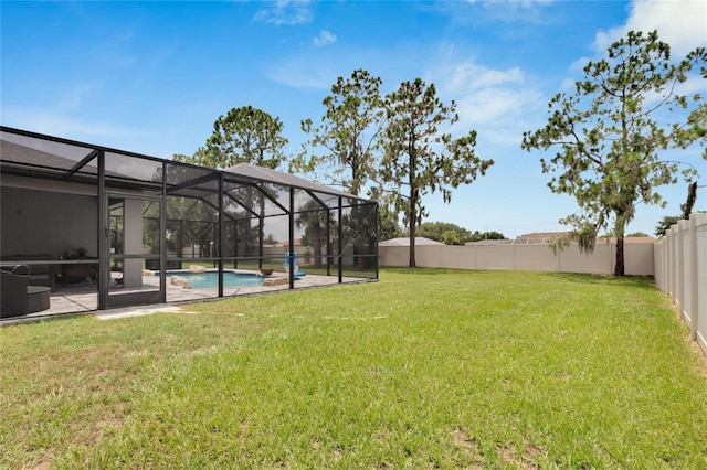 view of yard featuring glass enclosure, a patio area, and a fenced in pool