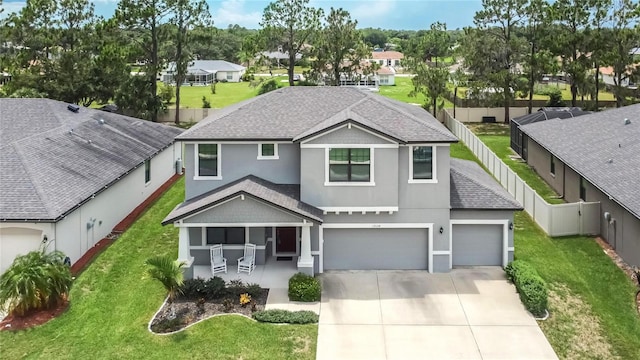 view of front of property featuring a garage and a front lawn