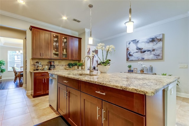 kitchen with a center island with sink, light stone counters, crown molding, and sink