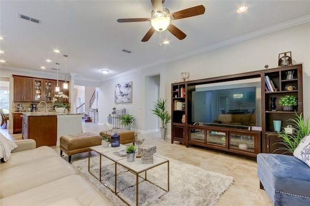 living room featuring ceiling fan and ornamental molding