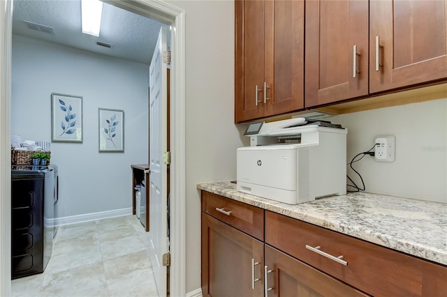 laundry area with cabinets, a textured ceiling, and independent washer and dryer