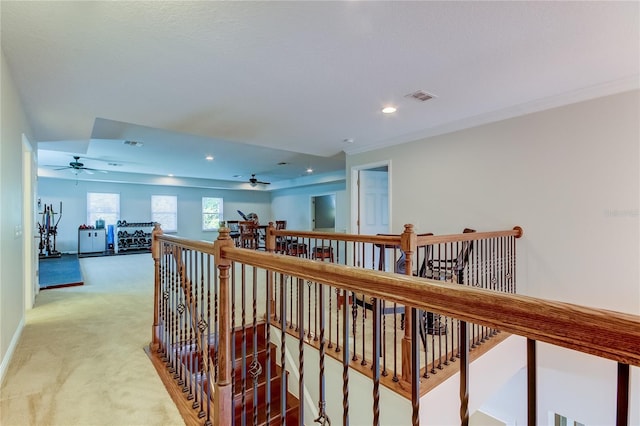 hall with carpet and ornamental molding