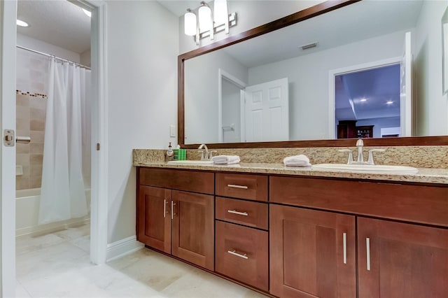 bathroom featuring vanity and shower / bathtub combination with curtain