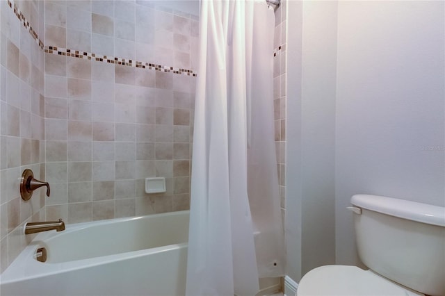 bathroom featuring shower / bath combo with shower curtain and toilet