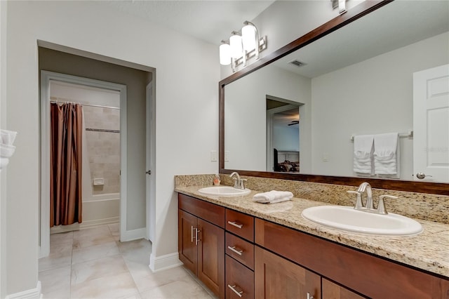 bathroom with shower / bath combo with shower curtain, vanity, and tile patterned flooring